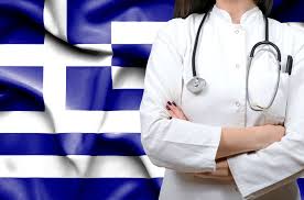 Doctor in a white coat with a stethoscope around their neck, standing with arms crossed, against the backdrop of the Greek flag.