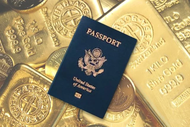 passport of united states on top of gold bars