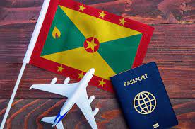 Grenada passport placed on a fabric background featuring the Grenadian flag.