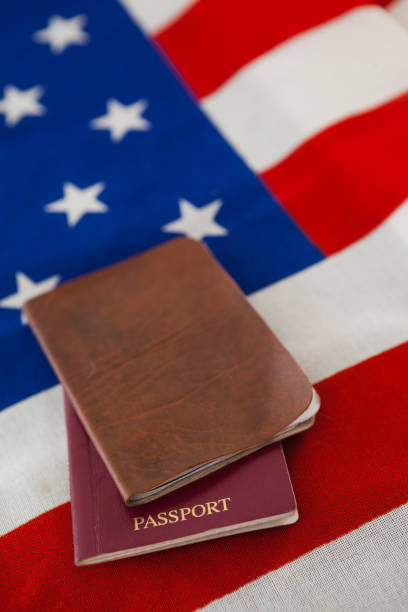 Close-up of passport and visa on an American flag