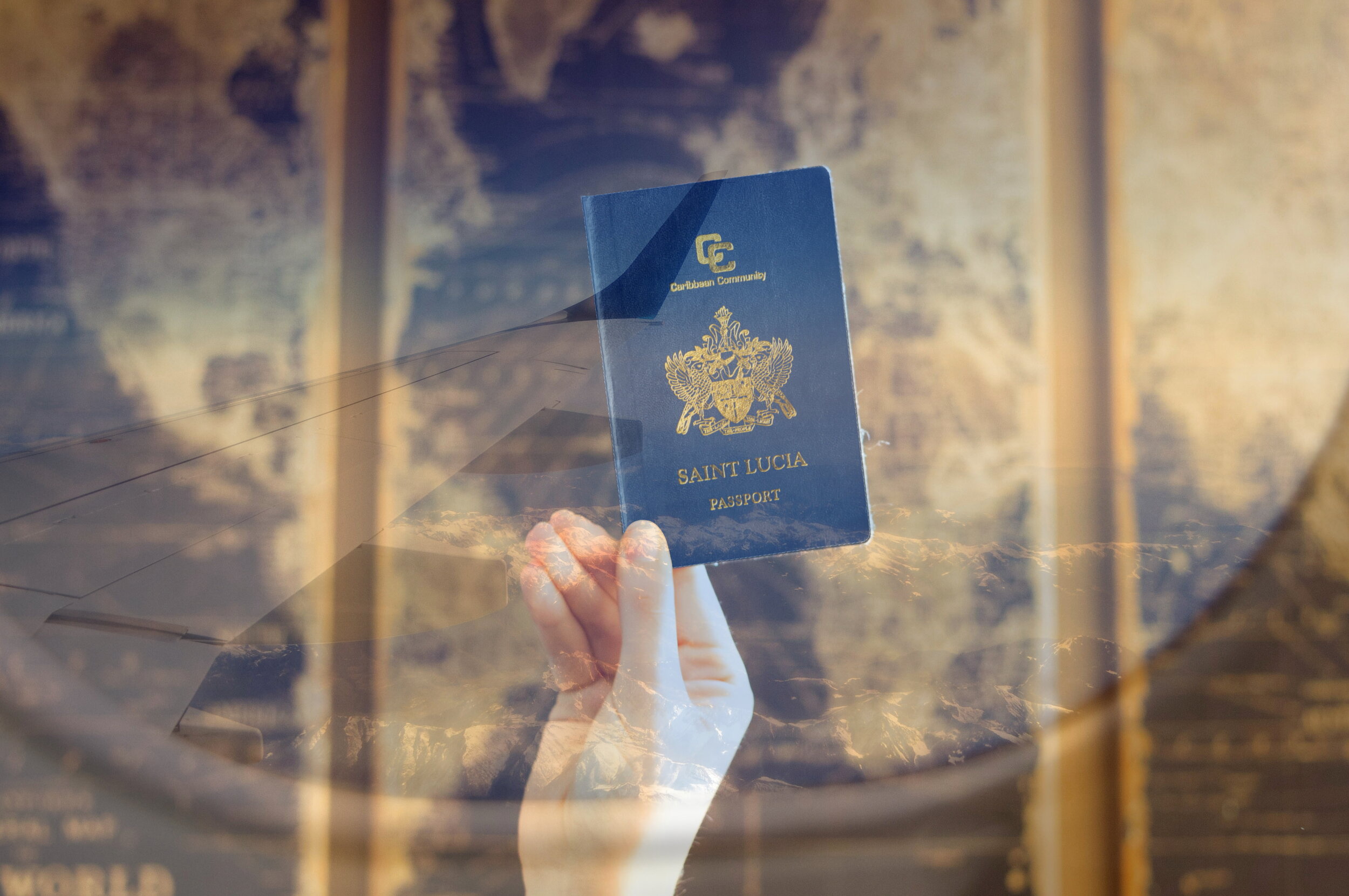 person holding saint lucia passport in the air